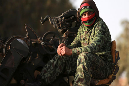 A member of Libyan pro-government forces, which is backed by the locals, looks on in an army camp, in Benghazi February 1, 2015. (Reuters)