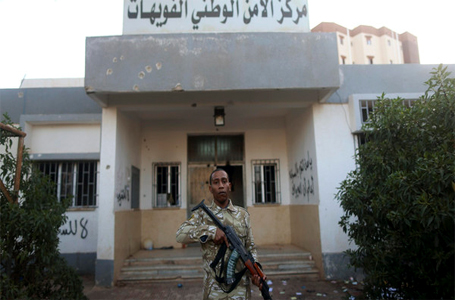 An armed security guard stands in front of a police station in Benghazi December 4, 2014. (Reuters)
