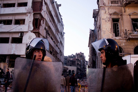 In this file photo taken Tuesday, Dec. 24, 2013, Egyptian policemen stand guard at the scene of a powerful explosion believed to be a car bomb. (File: AP)