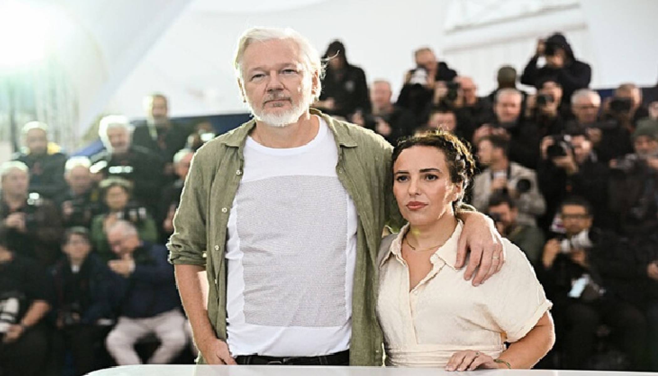 Cannes Festival. Assange wears a T-shirt with the names of some 5,000 children killed in Gaza