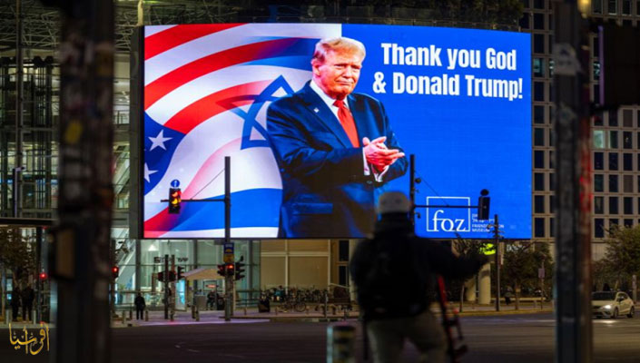 A digital billboard displays President Trump's picture and the phrase "Thank God and Donald Trump" along a Tel Aviv street 