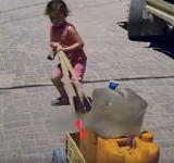 A child carries the weight of a thirsty city... And a mother who graduated before her son 